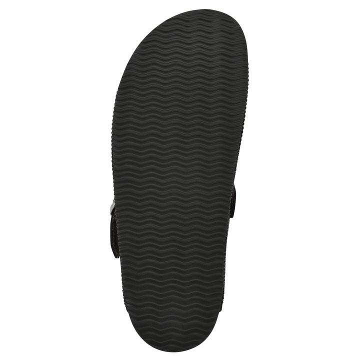 Sole view of a black micro-sequined backless clog with adjustable buckle strap and black sole