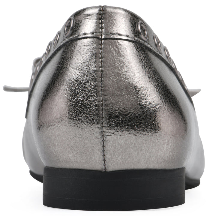 Rear view of a pewter metallic flat with small, centered bow, silver metal grommet lining and a black sole