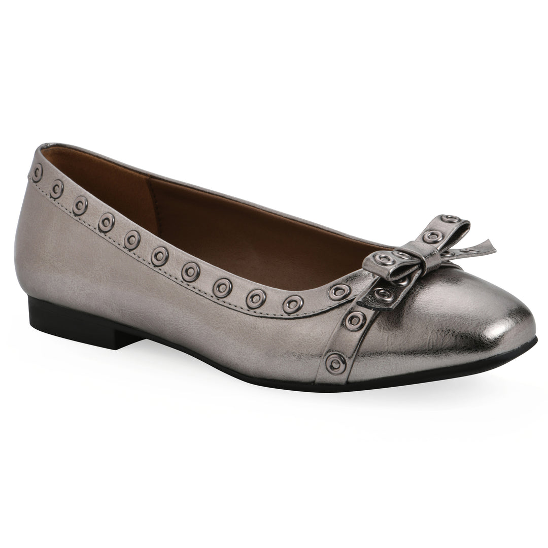 Angle view of a pewter metallic flat with small, centered bow, silver metal grommet lining and a black sole