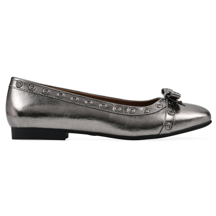 Side view of a pewter metallic flat with small, centered bow, silver metal grommet lining and a black sole