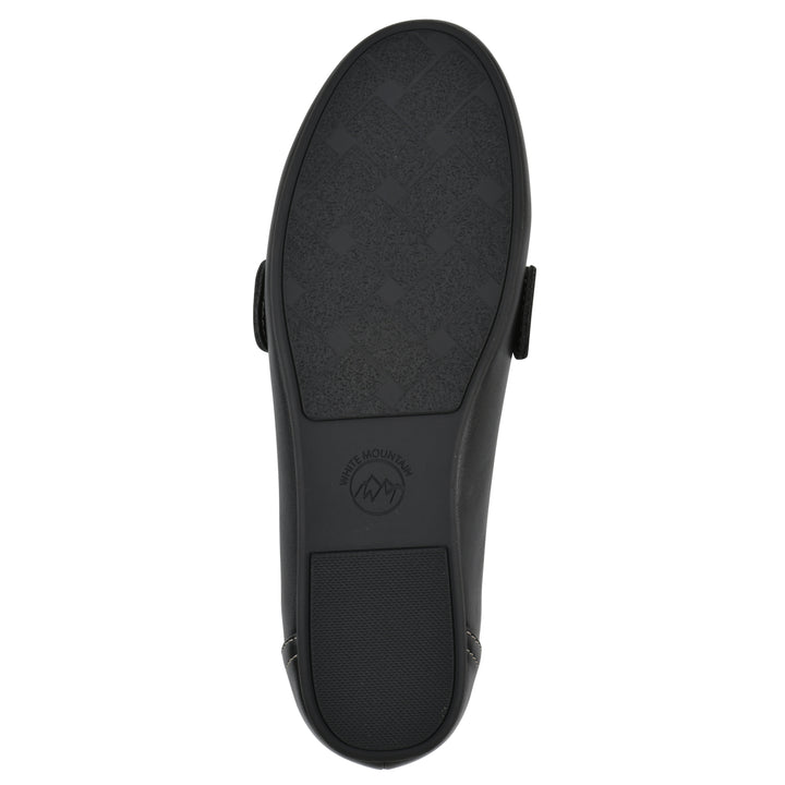 Sole view of a black loafer shoe with gold buckle 