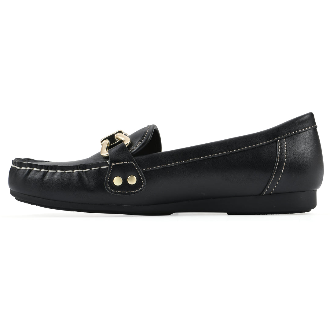 Side view of a black loafer shoe with gold buckle 