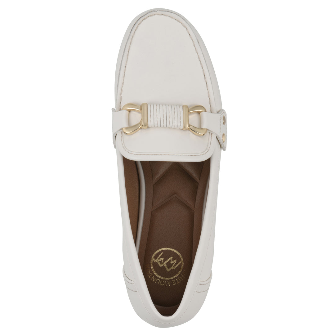White loafer with gold buckle on a white background, top view 
