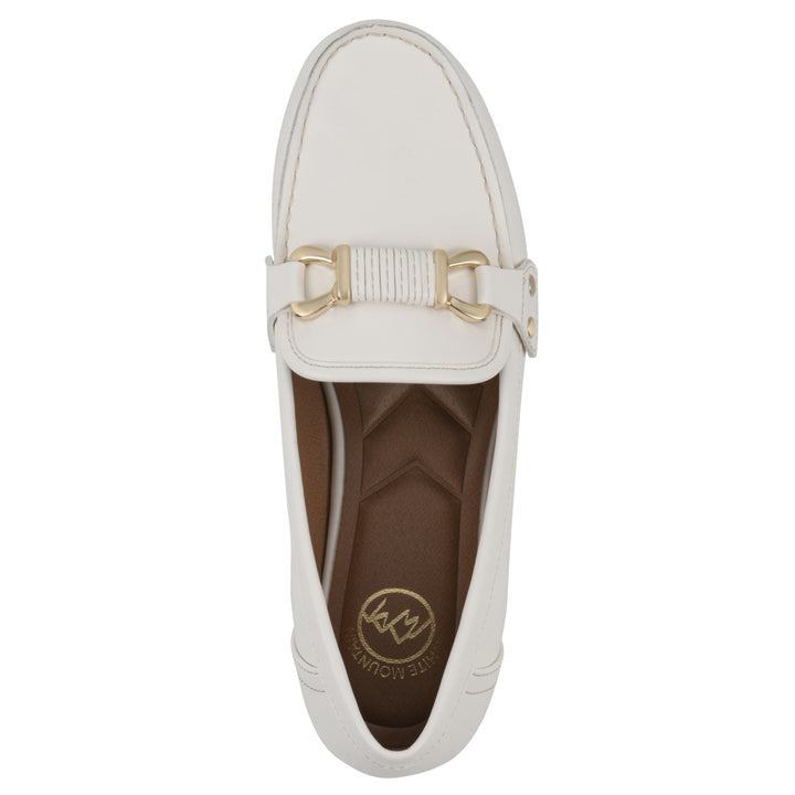 White loafer with gold buckle on a white background, top view 