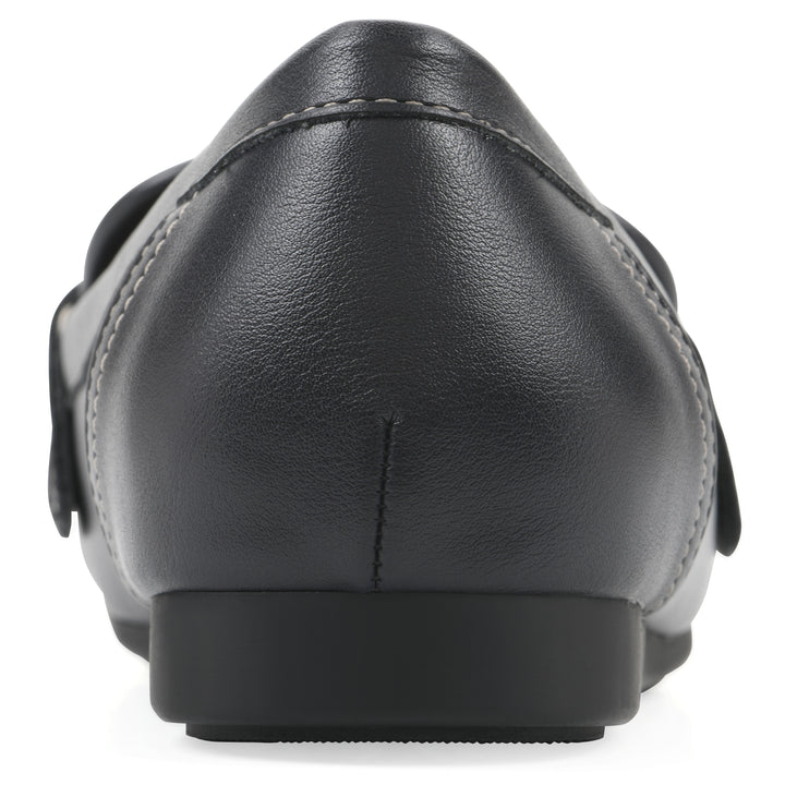 Rear view of a navy loafer shoe with gold buckle 