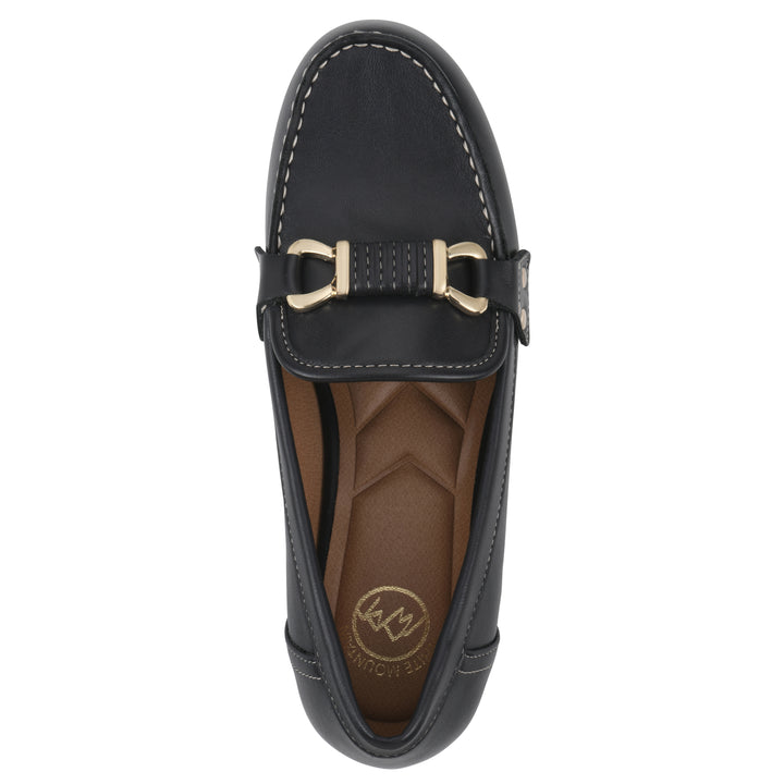 Top view of a navy loafer shoe with gold buckle 