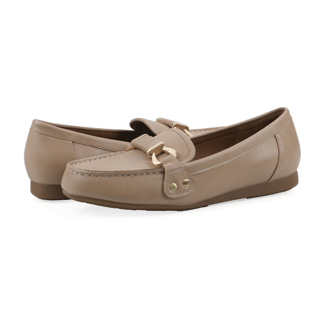 Angle view of a pair of beige loafer with a gold emblem