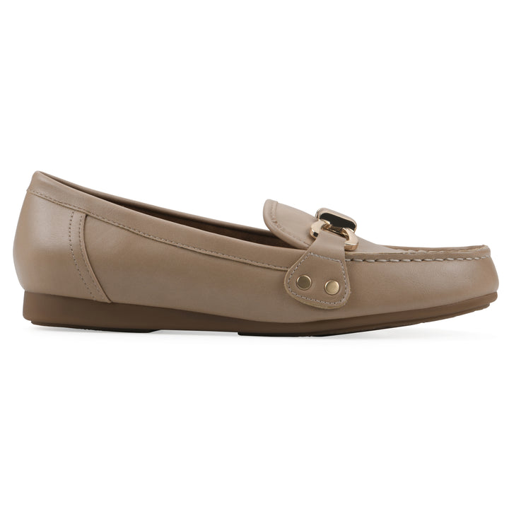 Side view of a beige loafer with a gold emblem