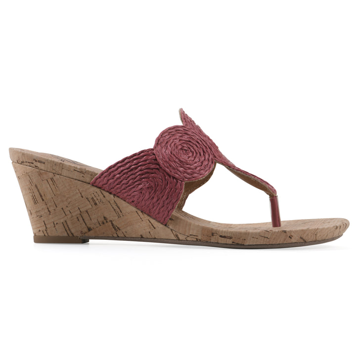 Side view of a cork print wedge sandal with red raffia thong design