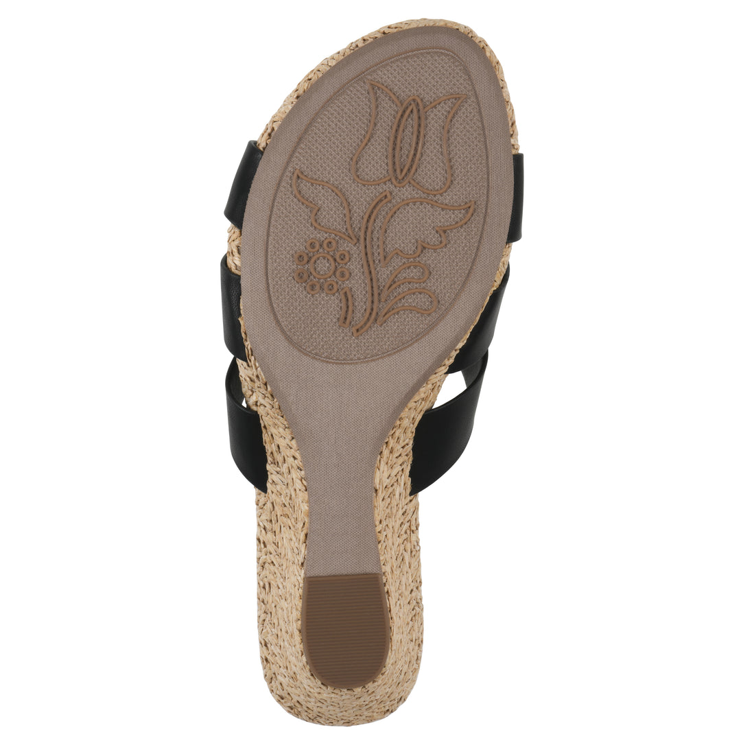 Sole view of a black wedge sandal with elastic heel strap, woven raffia sole and a centered, sequin applique