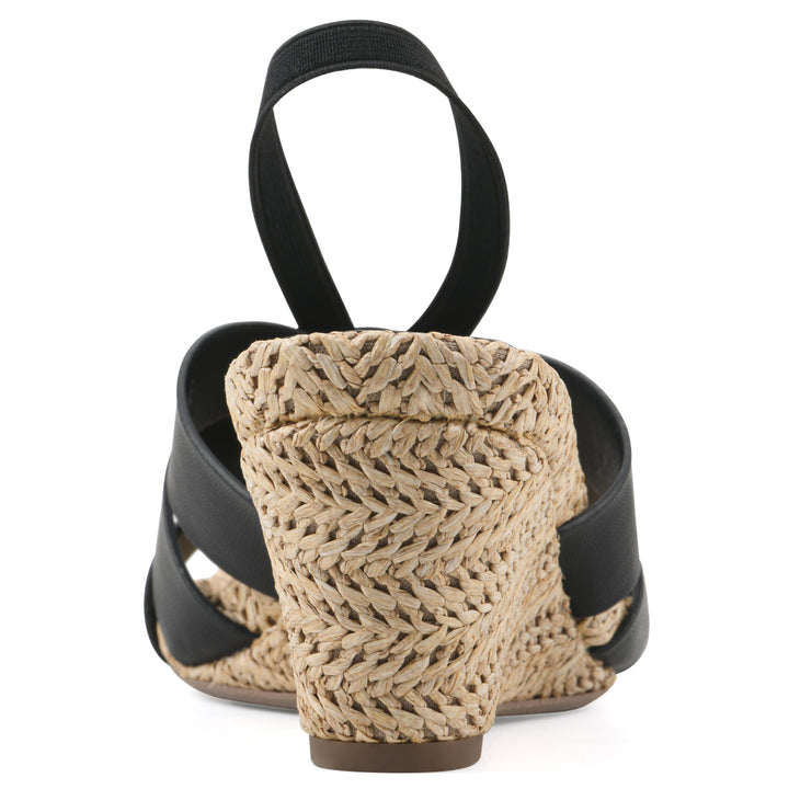 Rear view of a black wedge sandal with elastic heel strap, woven raffia sole and a centered, sequin applique