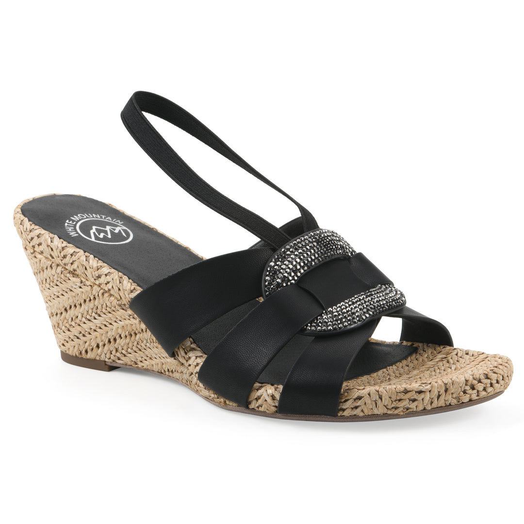 Angle view of a black wedge sandal with elastic heel strap, woven raffia sole and a centered, sequin applique