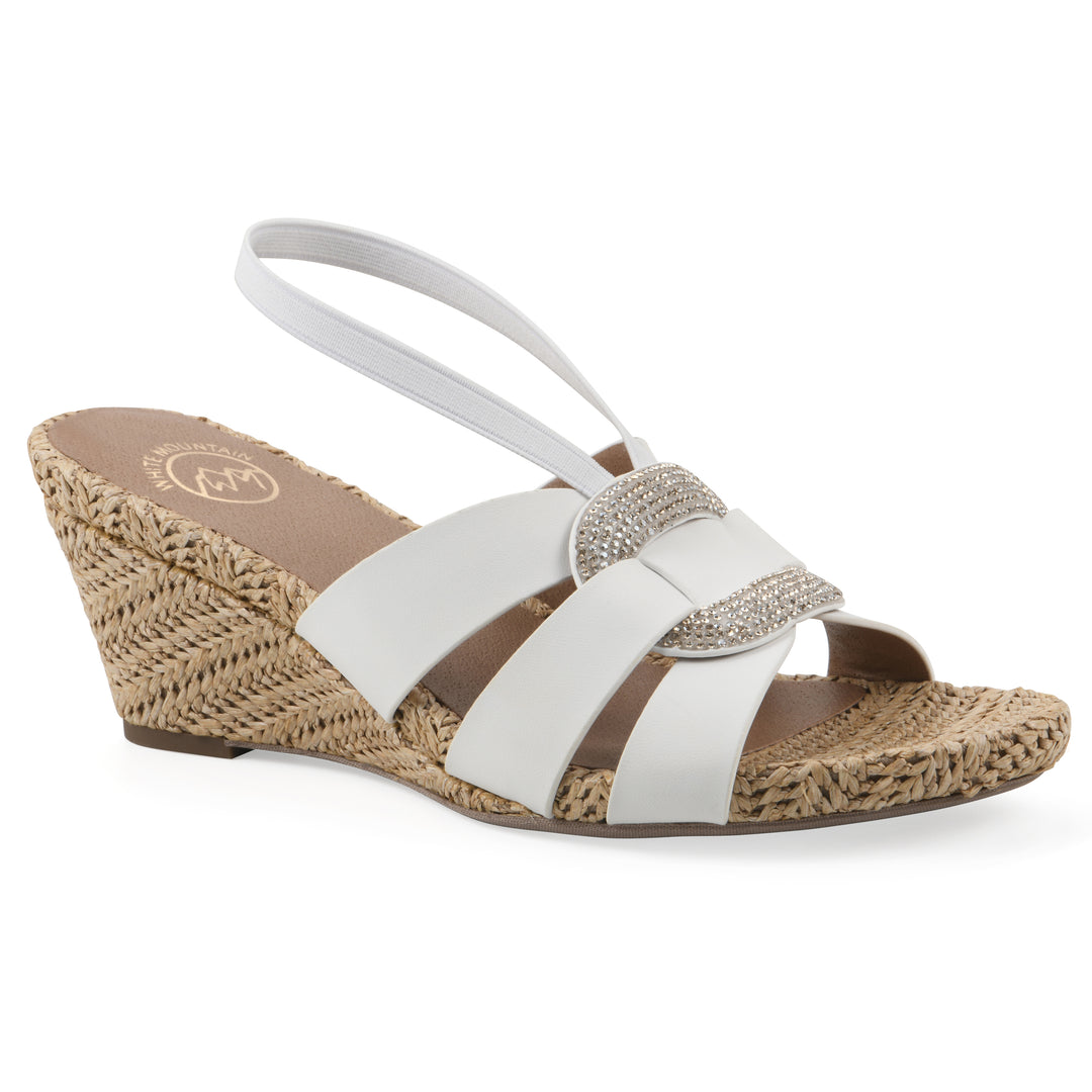 Angle view of a white wedge sandal with elastic heel strap, woven raffia sole and a centered, sequin applique