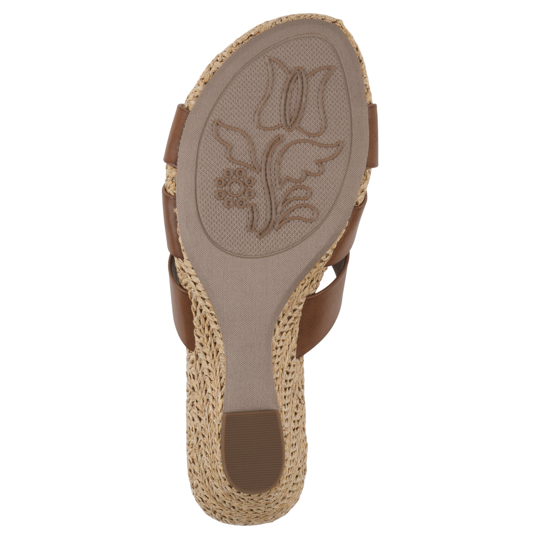 Sole view of a brown wedge sandal with elastic heel strap, woven raffia sole and a centered, sequin applique