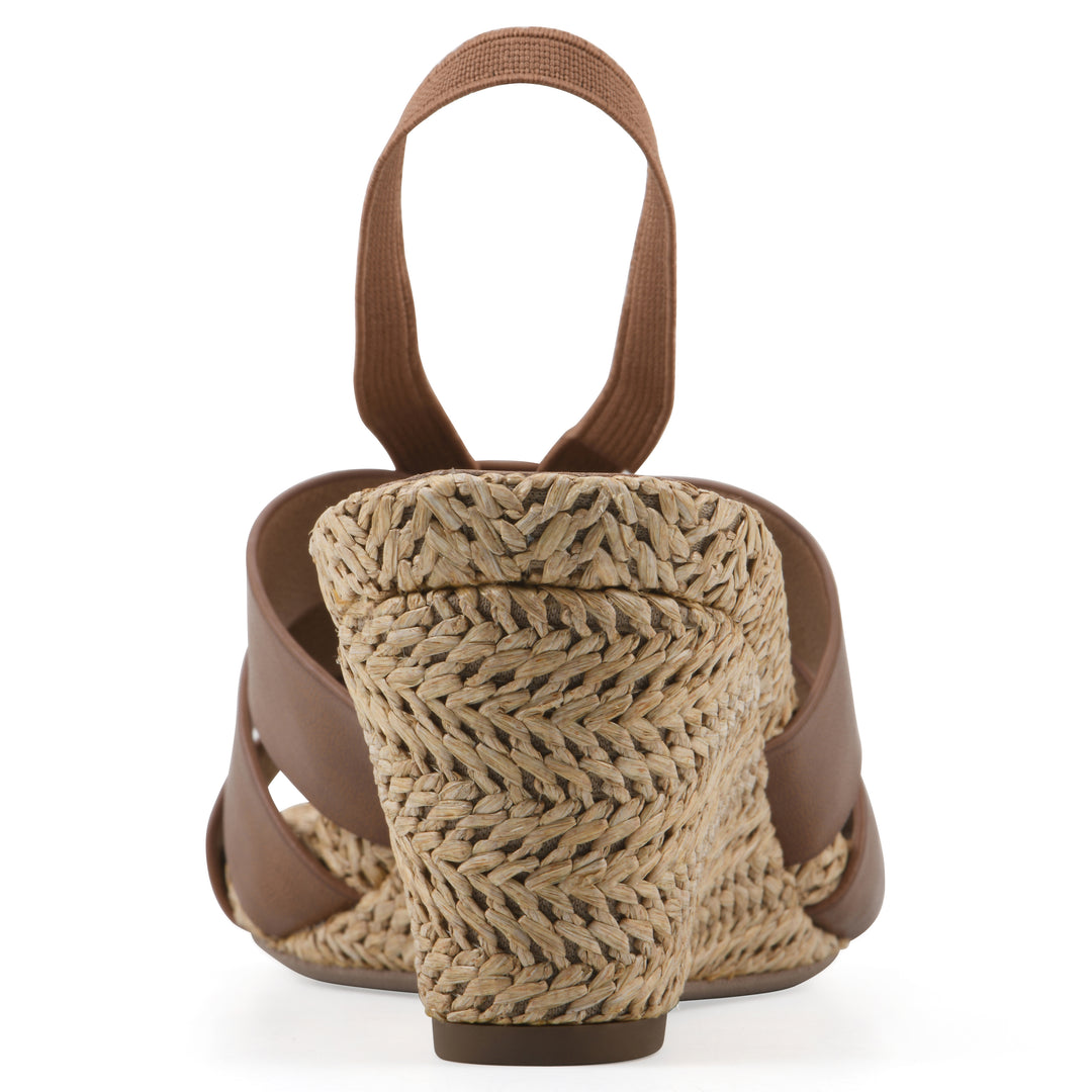 Rear view of a brown wedge sandal with elastic heel strap, woven raffia sole and a centered, sequin applique