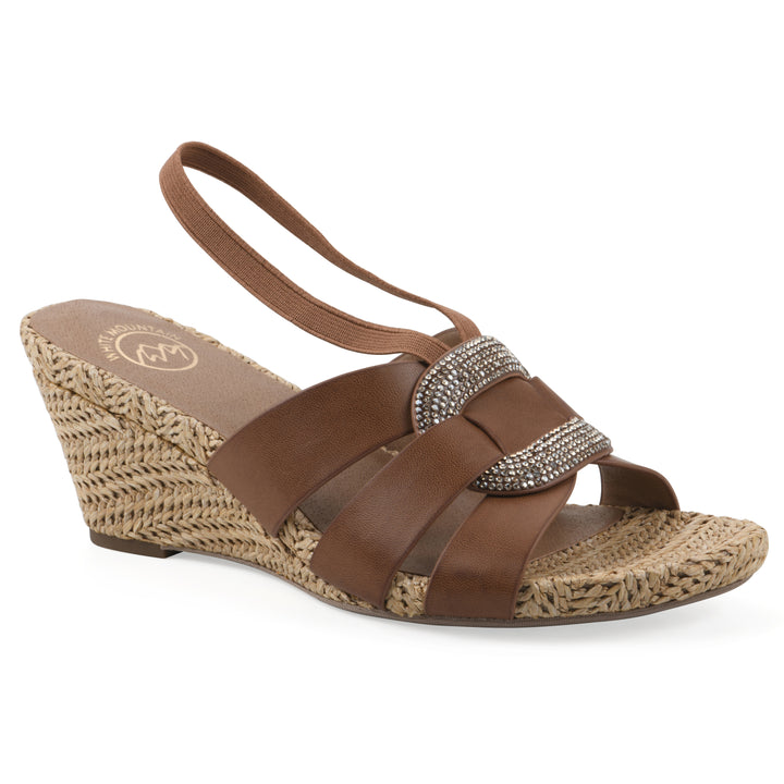 Angle view of a brown wedge sandal with elastic heel strap, woven raffia sole and a centered, sequin applique