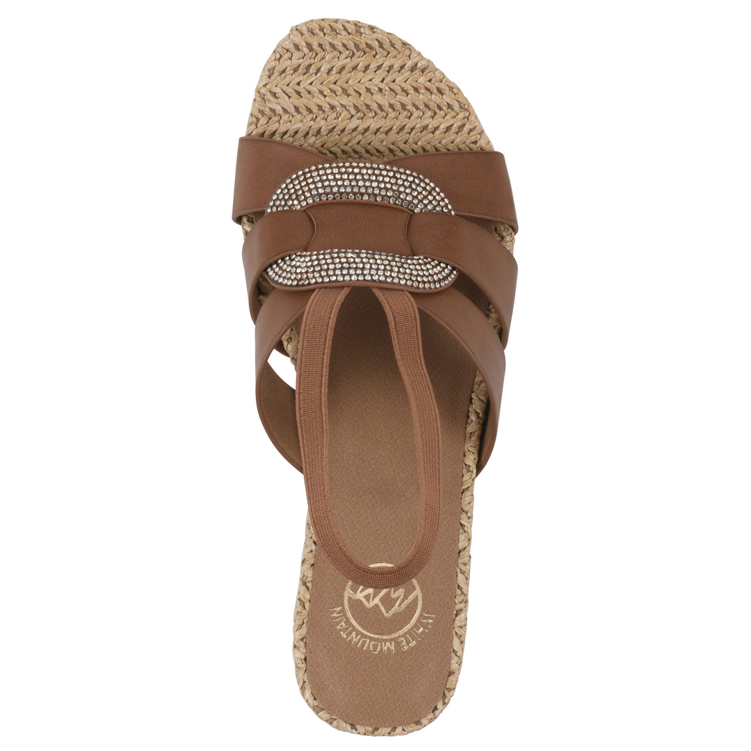 Top view of a brown wedge sandal with elastic heel strap, woven raffia sole and a centered, sequin applique