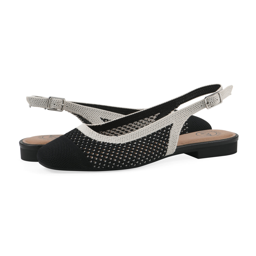 Angle view of a pair of black and white fly-knit slingbacks with low black heel