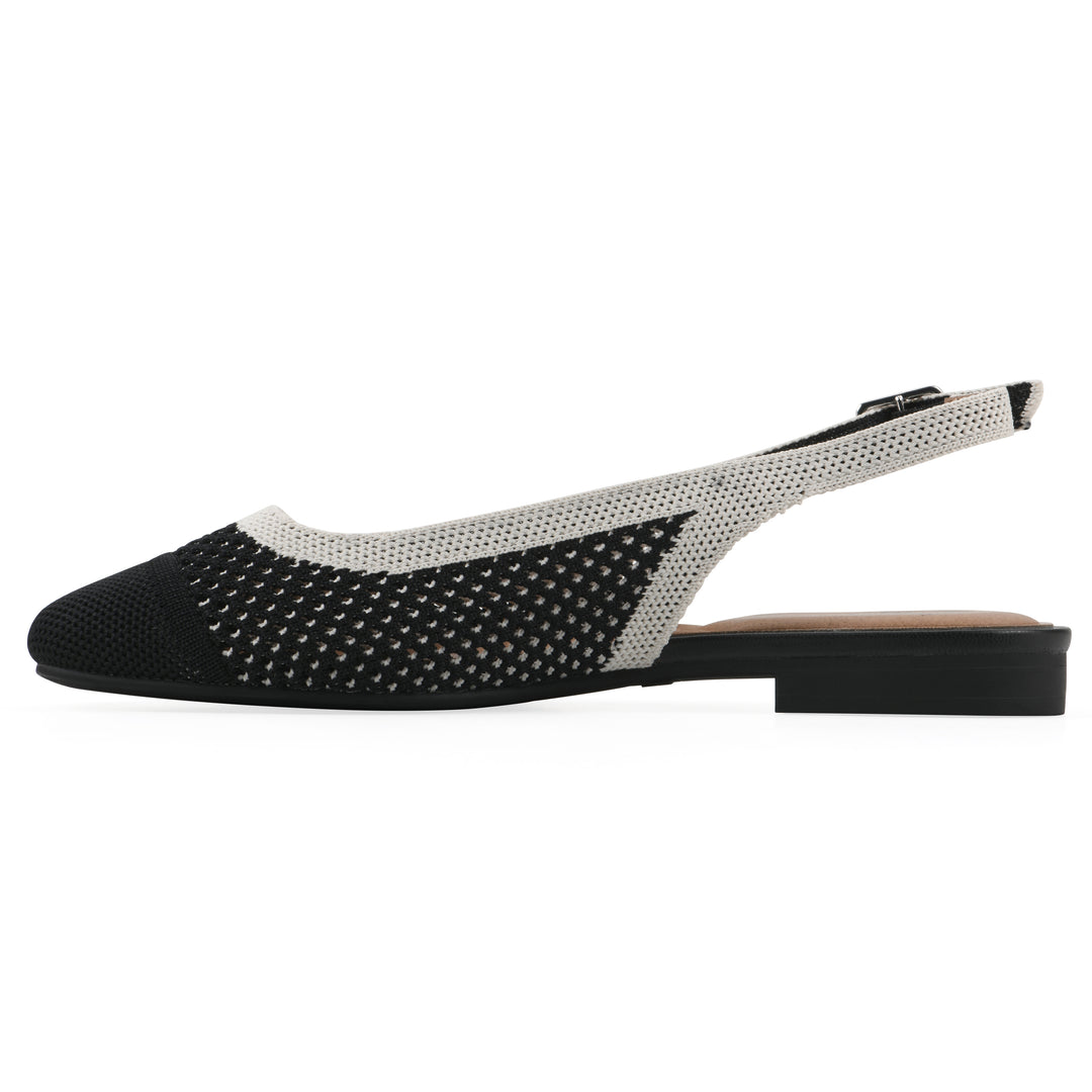 Side view of a black and white fly-knit slingback with low black heel