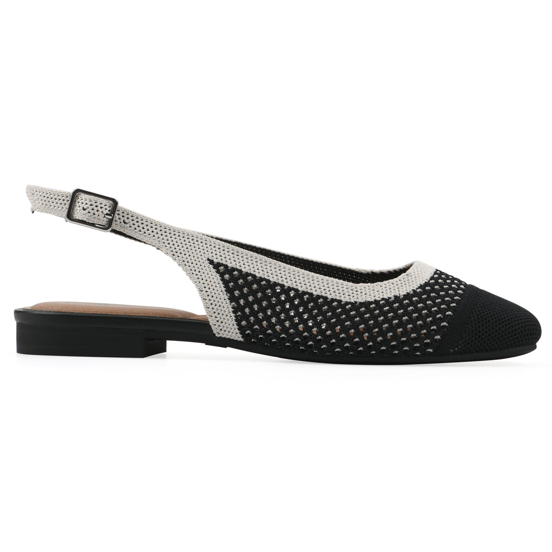 Side view of a black and white fly-knit slingback with low black heel
