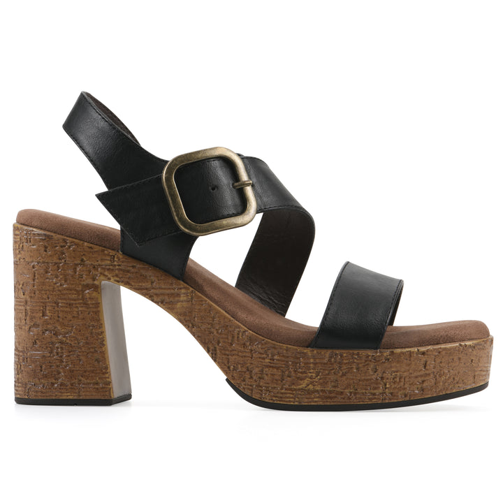 Side view of a black platform sandal with ankle buckle and a brown, faux cork sole