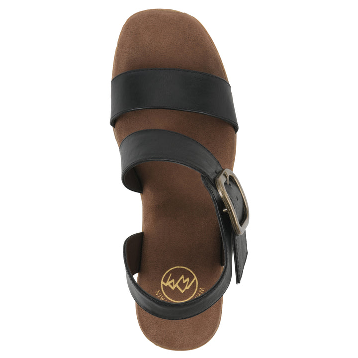 Top view of a black platform sandal with ankle buckle and a brown, faux cork sole