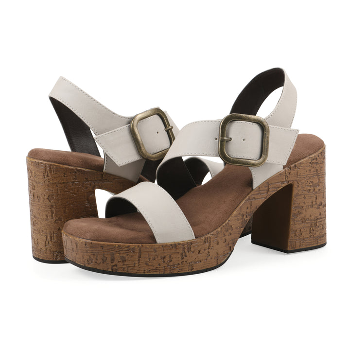Angled view of a pair of white platform sandals with ankle buckle and a brown, faux cork sole