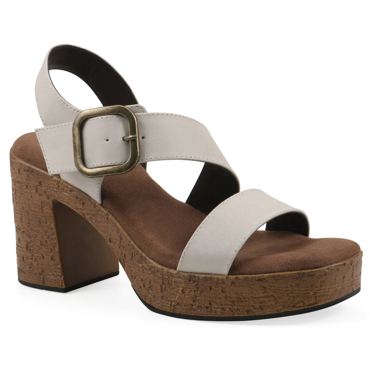 Angle view of a white platform sandal with ankle buckle and a brown, faux cork sole
