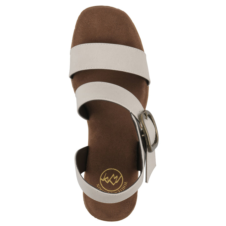 Top view of a black platform sandal with ankle buckle and a brown, faux cork sole