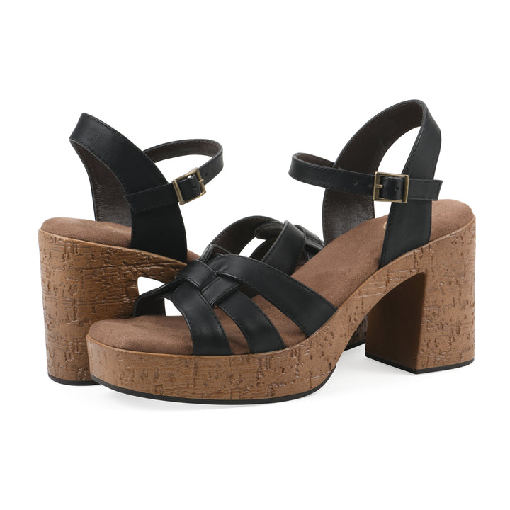 Angle view of a pair of black faux leather platform sandals with buckle style ankle strap and a brown molded cork sole
