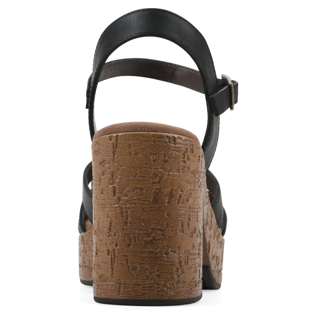 Rear view of a black faux leather platform sandal with buckle style ankle strap and a brown molded cork sole
