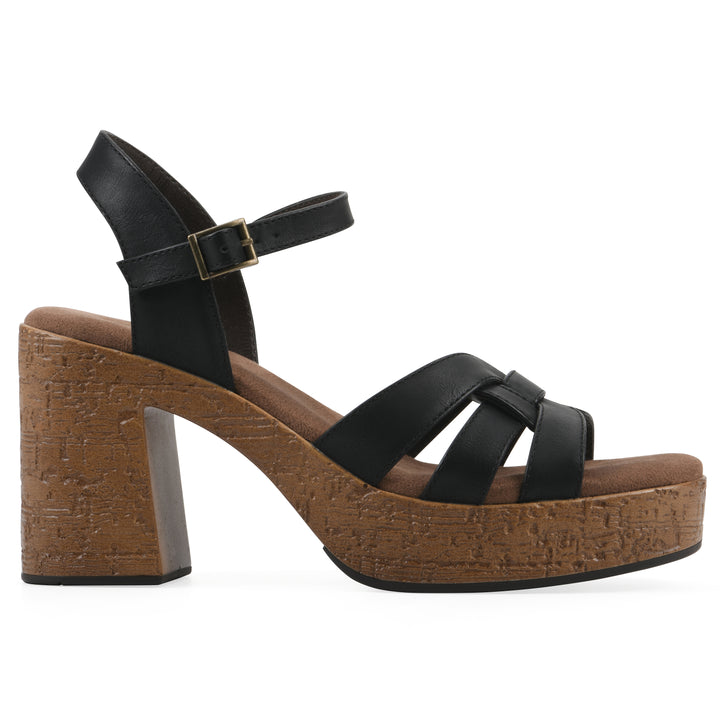 Side view of a black faux leather platform sandal with buckle style ankle strap and a brown molded cork sole