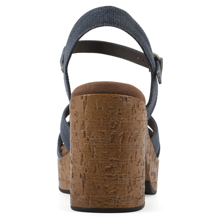 Rear view of a denim blue fabric platform sandal with buckle style ankle strap and a brown molded cork sole