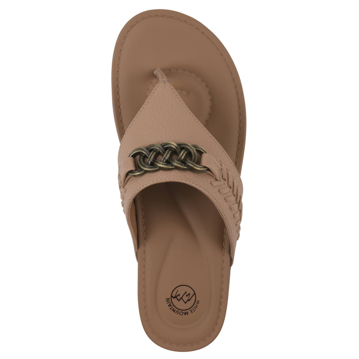 Top view of a tan thong sandal with metal embellishment and a brown sole