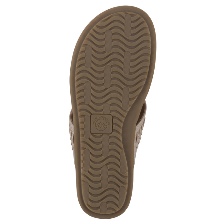 Sole view of a light gold thong sandal with metal embellishment and a brown sole