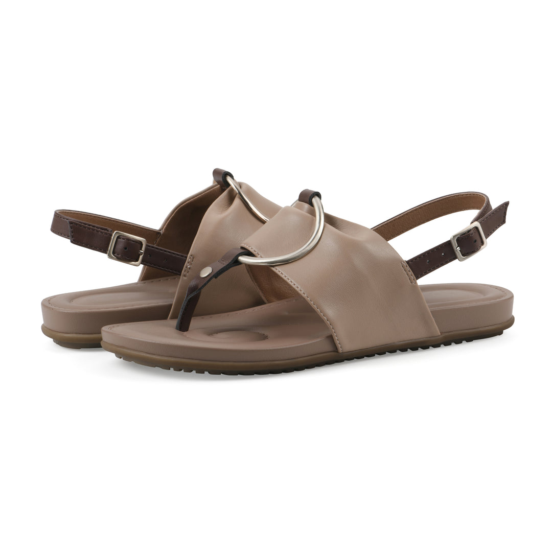 Angle view of a pair of tan thong sandals with a centered metallic ring, adjustable heel strap, and beige sole