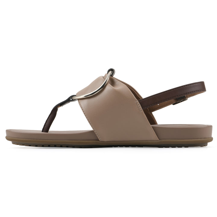 Side view of a tan thong sandal with a centered metallic ring, adjustable heel strap, and beige sole