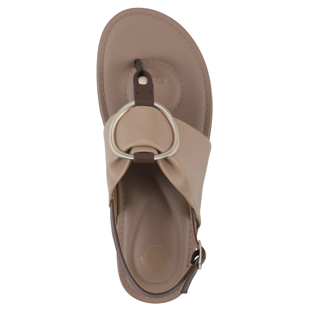 Top view of a tan thong sandal with a centered metallic ring, adjustable heel strap, and beige sole