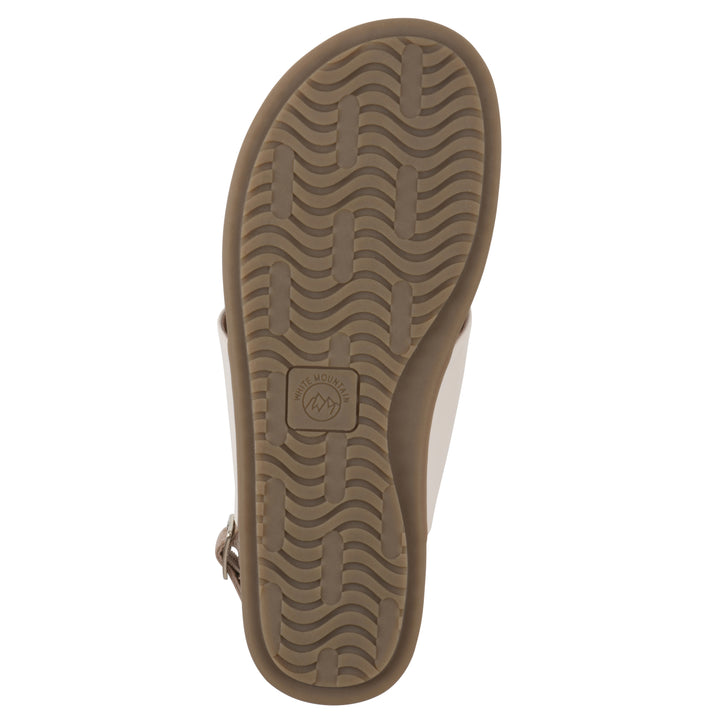 Sole view of a cream thong sandal with a centered metallic ring, adjustable heel strap, and beige sole