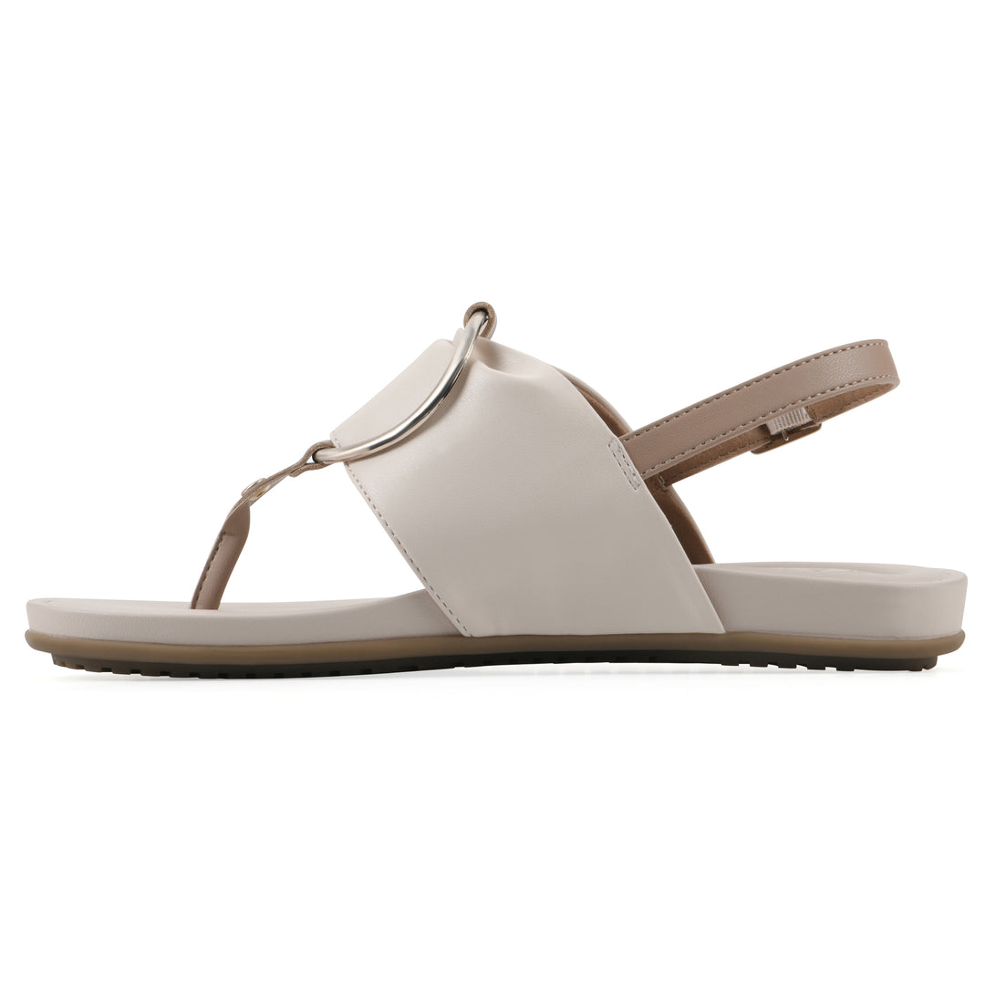 Side view of a cream thong sandal with a centered metallic ring, adjustable heel strap, and beige sole