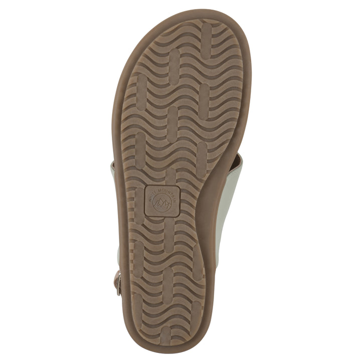 Sole view of a sage thong sandal with a centered metallic ring, adjustable heel strap, and beige sole