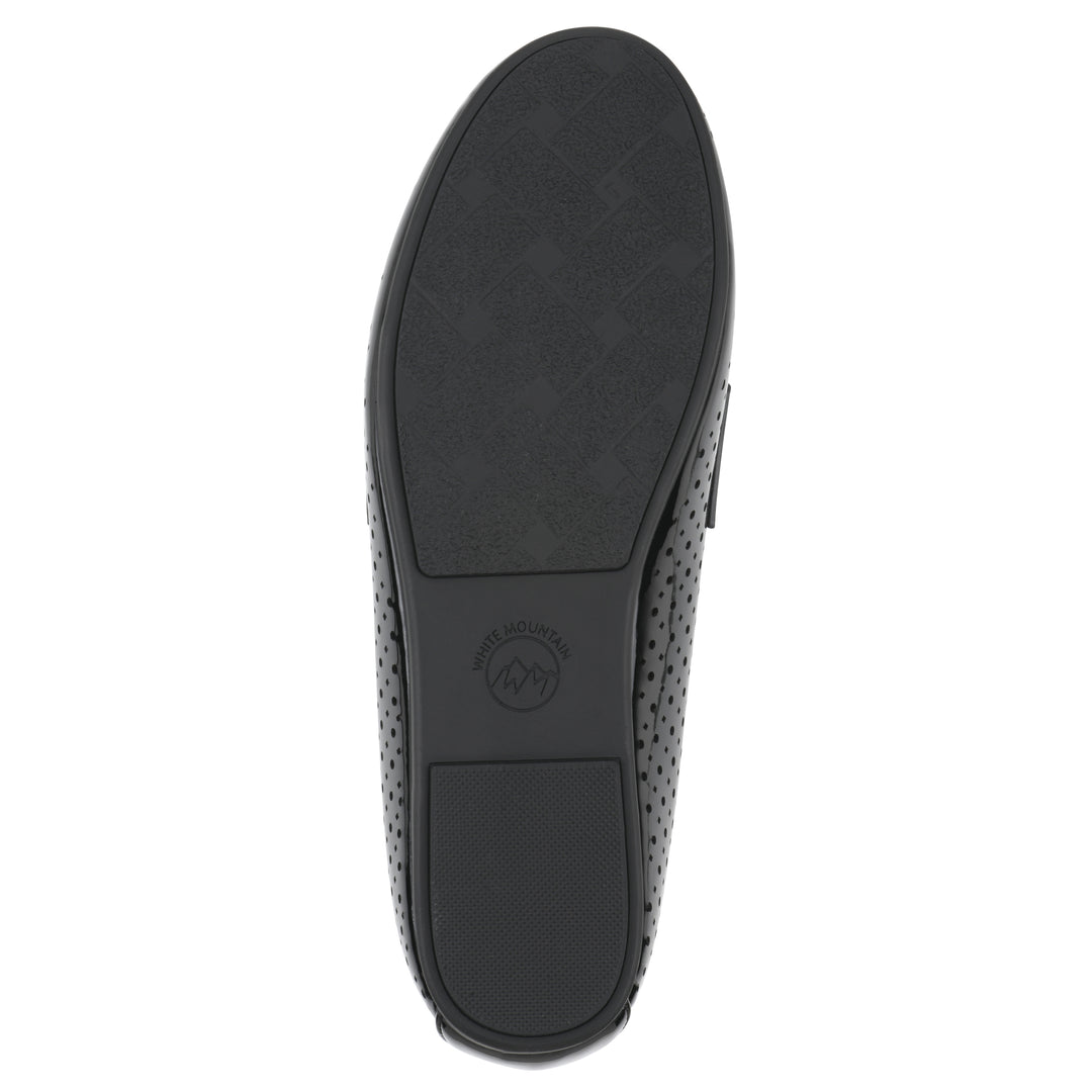 Sole view of a black patent perforated loafer shoe 