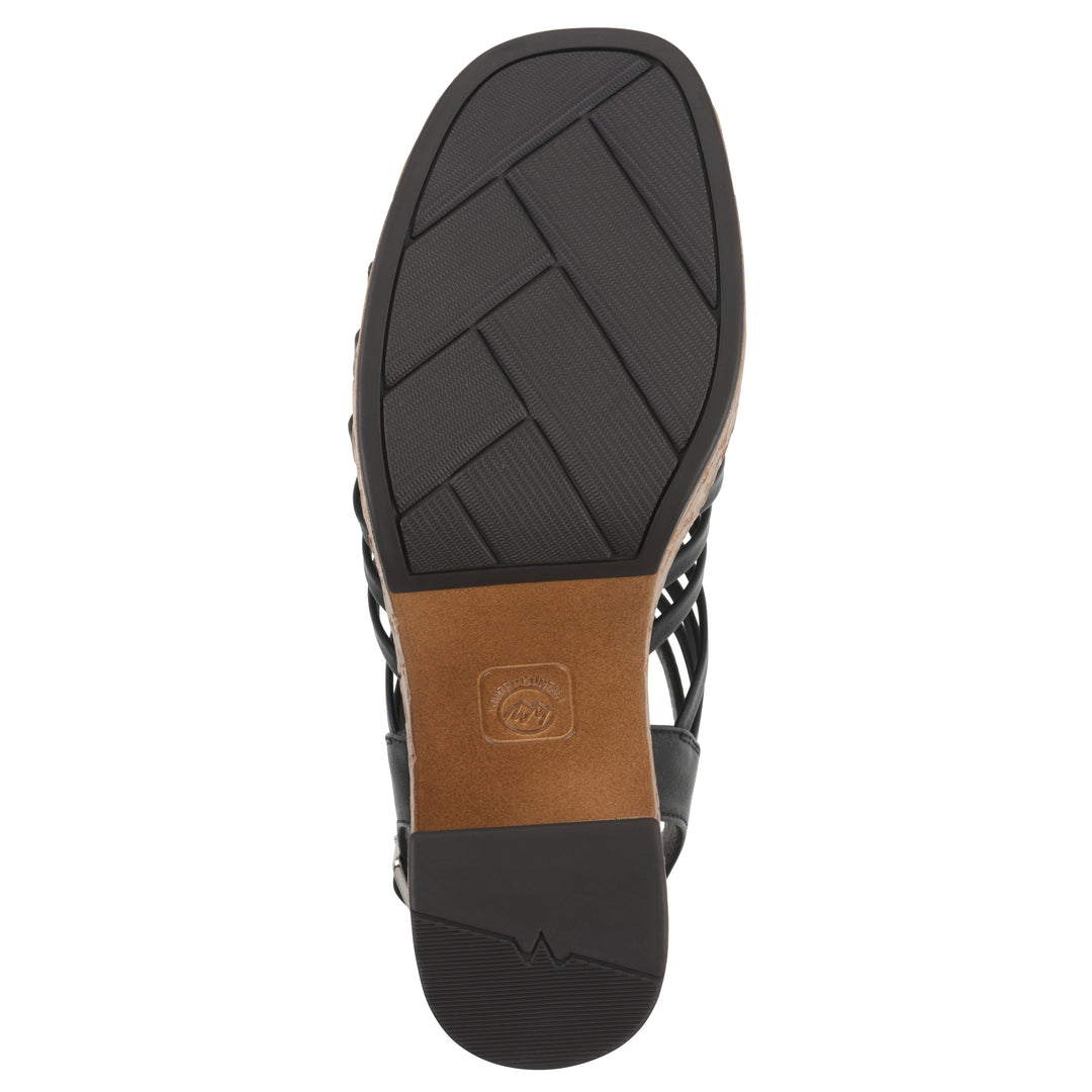 Sole view of a black gladiator platform sandal with adjustable ankle buckle and cork style heel