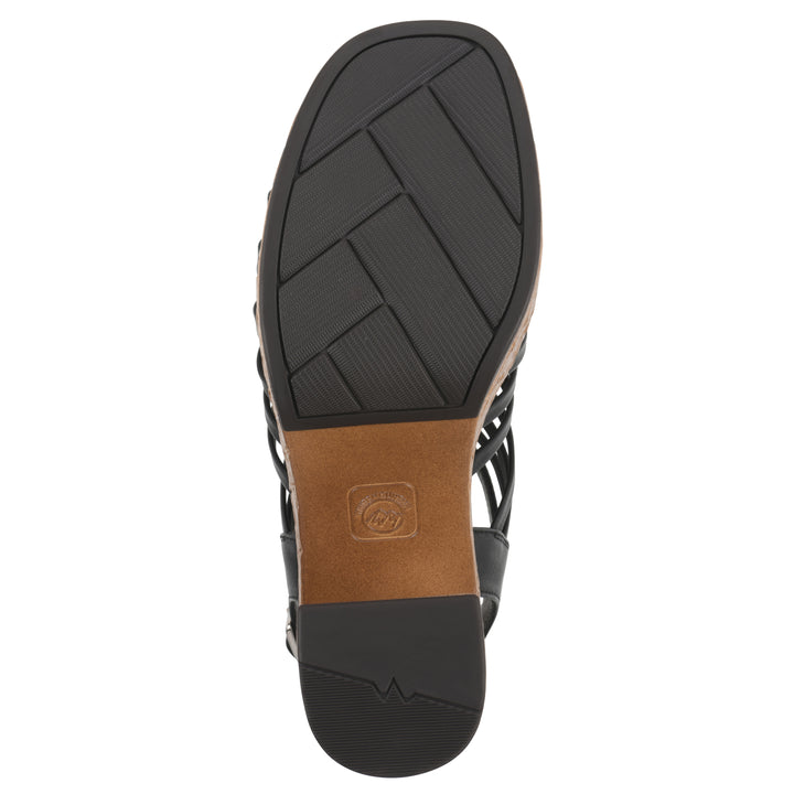 Sole view of a black gladiator platform sandal with adjustable ankle buckle and cork style heel