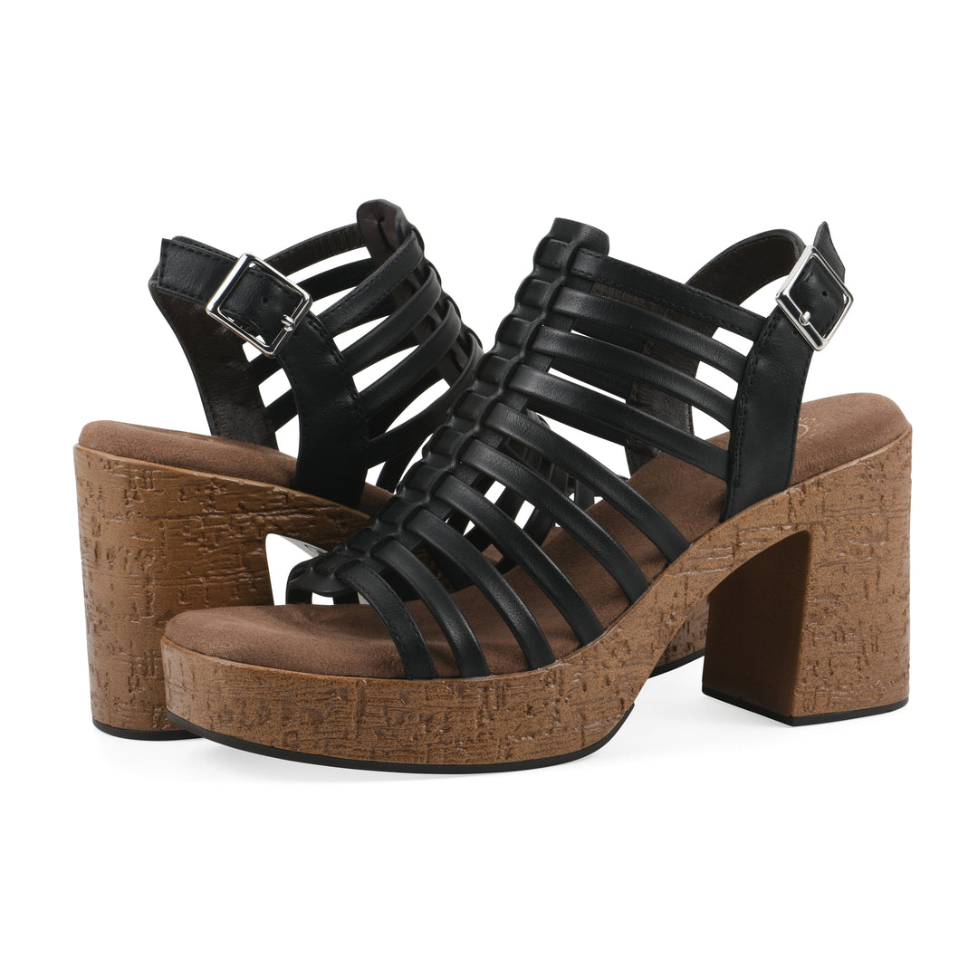 Angle view of a pair of black gladiator platform sandals with adjustable ankle buckle and cork style heel