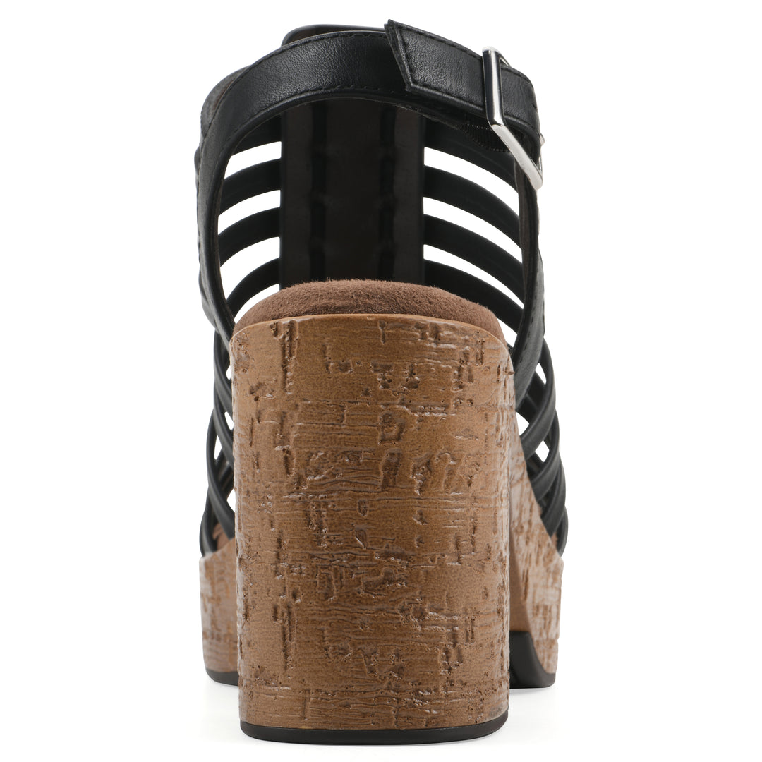 Rear view of a black gladiator platform sandal with adjustable ankle buckle and cork style heel