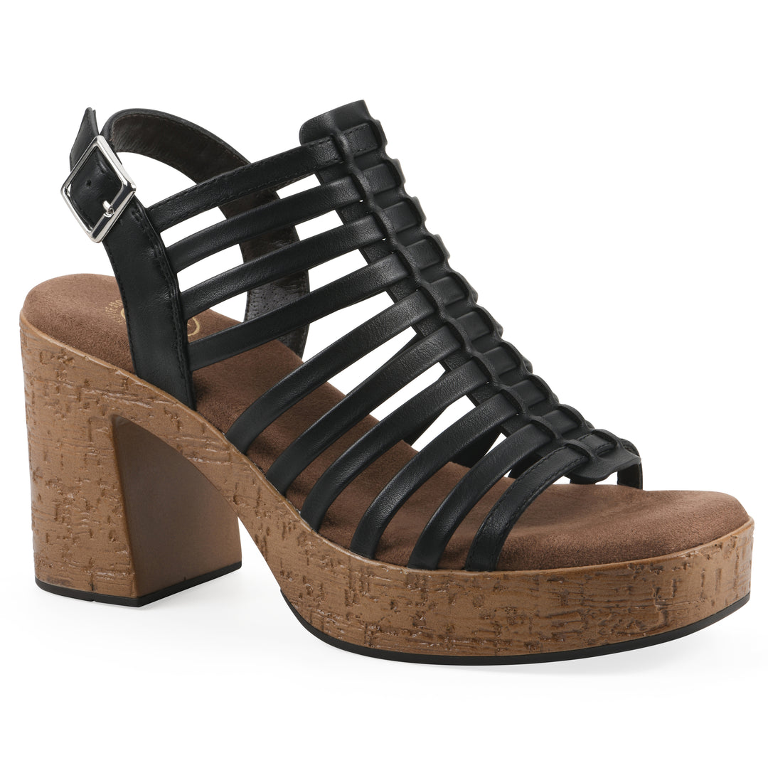 Angle view of a black gladiator platform sandal with adjustable ankle buckle and cork style heel