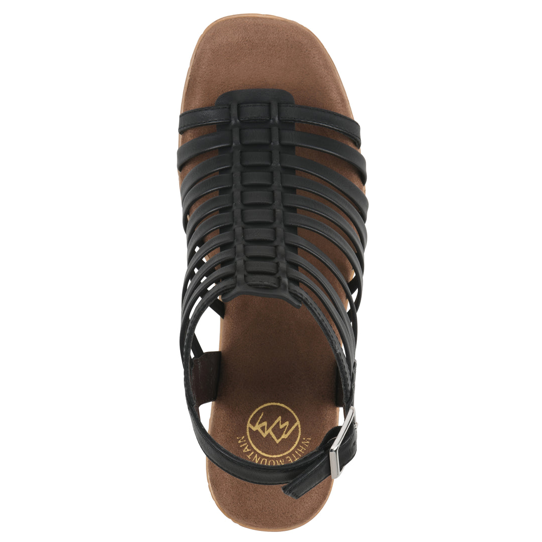 Top view of a black gladiator platform sandal with adjustable ankle buckle and cork style heel