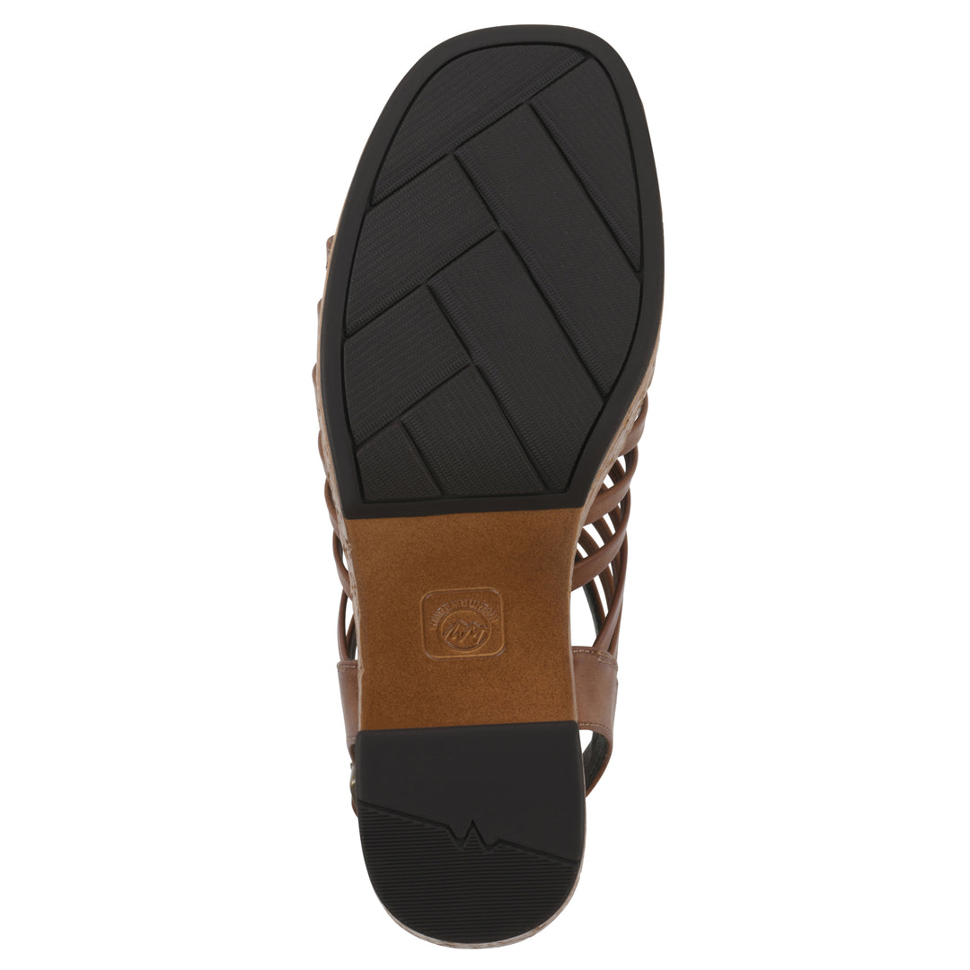 Sole view of a brown gladiator platform sandal with adjustable ankle buckle and cork style heel