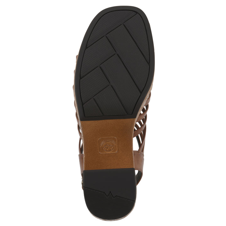 Sole view of a brown gladiator platform sandal with adjustable ankle buckle and cork style heel